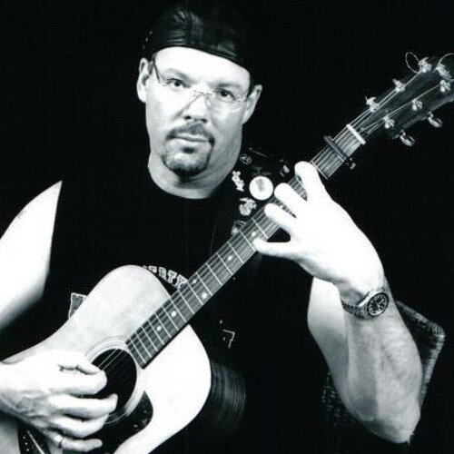 montgomery delaney playing a chord on the guitar