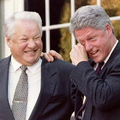 Boris Yeltsin and Bill Clinton arm in arm Clinton wiping one eye in laughter